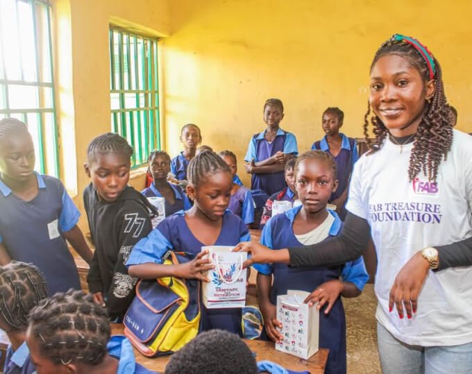 Picture showing FAB Team giving gift to students