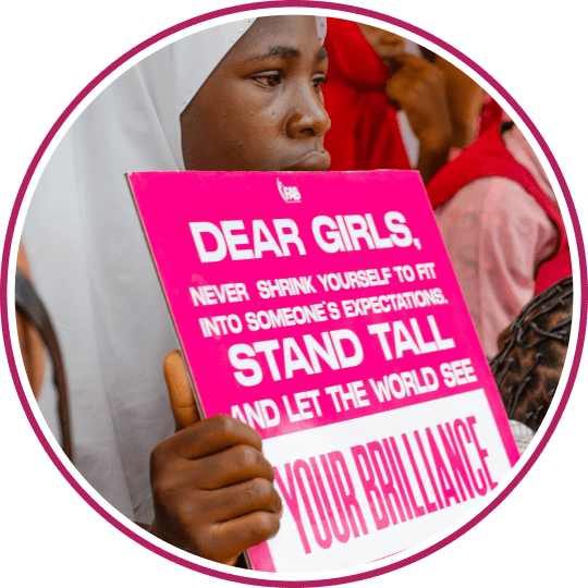 The image of a lady holding Girl believe in yourself banner